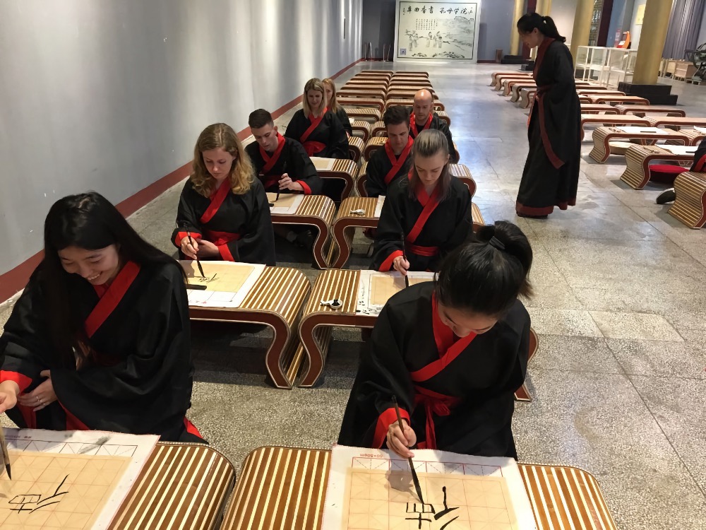 Teachers and students practice calligraphy